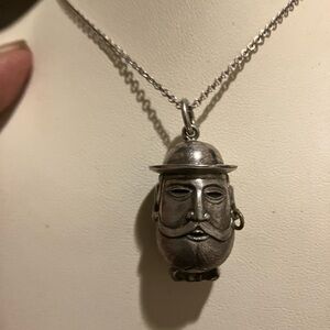 Antique fabrege egg pendent in silver of a European man .